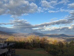 A mountainous landscape with a wooden deck and a view of distant hills. - Presidential Suite - Rm. 205 (Stanardsville)