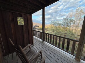 A wooden deck with a sign warning of rock, paper, and scissors. - Lydia Schoolhouse Rm. 112 (Stanardsville)