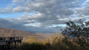 A scenic overlook with a wooden deck and a view of a forested valley. - Lydia Legends Rm. 111 (Stanardsville)