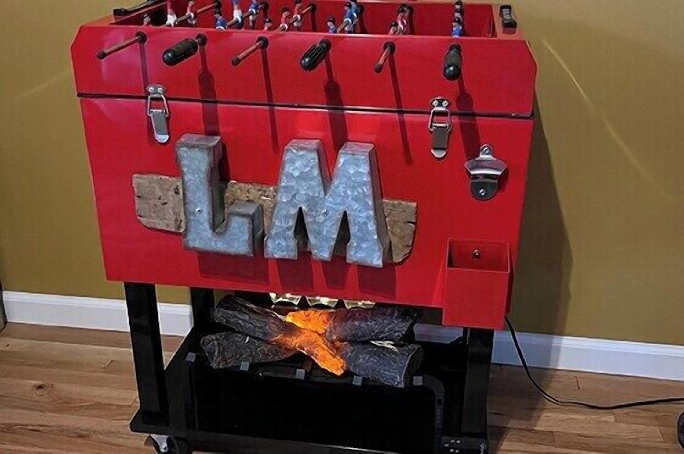 A red foosball table with the letters 'LM' on the front.