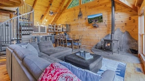 A log cabin interior with a living area, kitchen, and fireplace. - Cabin #10 - Our Mountain Cabin (Stanardsville)