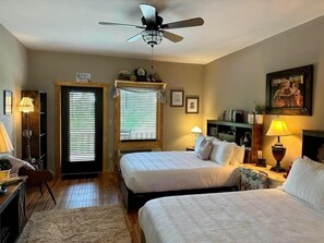 A bedroom with two beds, a ceiling fan, and a painting on the wall. - Once Upon A Time Rm. 103 (Stanardsville)