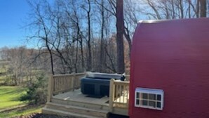A red RV with a wooden deck and a hot tub. - Monarch Meadows Cabin Pod (Stanardsville)
