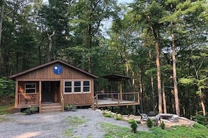 A cabin with a porch, a deck, and a fire pit. - Tucked Away Mountain Cabin (Stanardsville)
