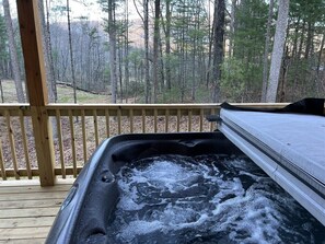A hot tub on a wooden deck with a forest view. - Almost Heaven Mountain Cabin (Stanardsville)