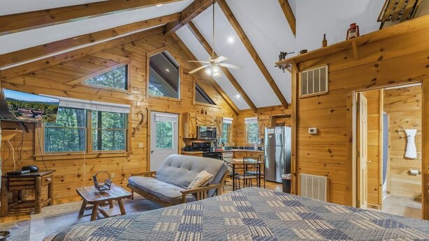 A log cabin with a bedroom, a dining area, and a kitchen. - Cabin #5 - Love Nest (Stanardsville)