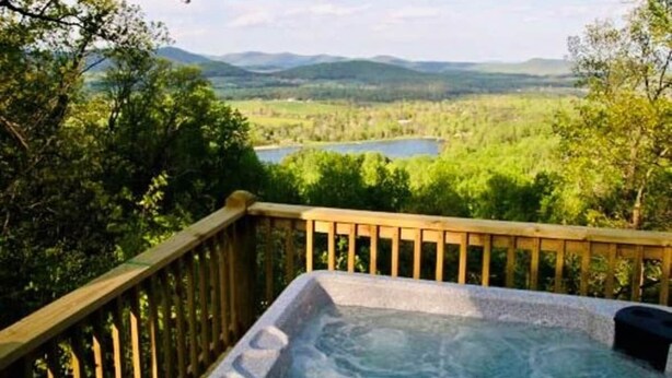 A hot tub on a wooden deck with a view of a lake and mountains. - My Lakeview Mountain Cabin (Stanardsville)