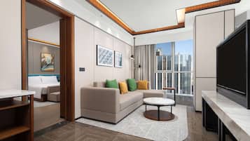 Deluxe Suite, 1 King Bed | Living area | 55-inch LED TV with cable channels