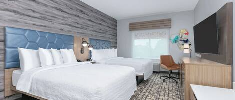 A hotel room with two beds, a desk, a chair, a TV, and a window with a view.
