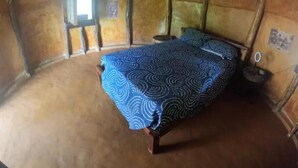 A room with a bed, a small table, and a window. - Private waterfall and indigenous house! (Minca)
