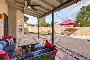 An outdoor patio area with a covered seating area, a barbecue grill, and a view of the backyard. - 3 Mi to Dtwn: Home w/ Heated Pool in Gilbert (Gilbert)