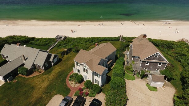 A coastal residential area with houses, a beach, and a clear view of the ocean. - 8 The Gridiron (Sandwich)