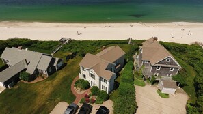 A coastal residential area with houses, a beach, and a clear view of the ocean. - 8 The Gridiron (Sandwich)