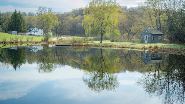 A serene lakeside scene with a house, a dock, and a reflection of trees. - Rustic and private farmhouse close to Lackawanna State Park, near Elk Mtn Ski  (Dalton)