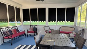 A covered patio with a table and chairs, a bench, and large windows overlooking a lawn. - Rustic and private farmhouse close to Lackawanna State Park, near Elk Mtn Ski  (Dalton)