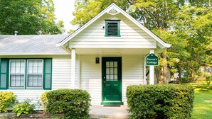 A white building with a green door and shutters, labeled "Steven's Cottage." - Private 1BR Cottage In Downtown Historic Norcross (Norcross)