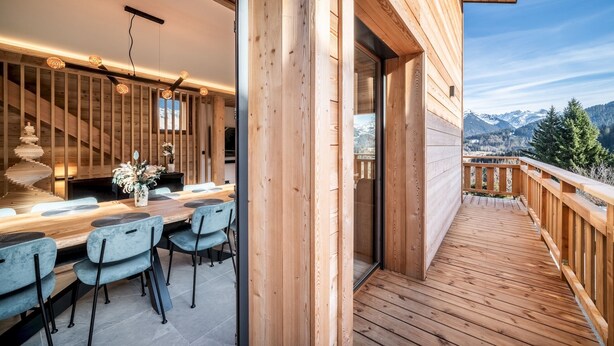 A wooden deck with a view of mountains.