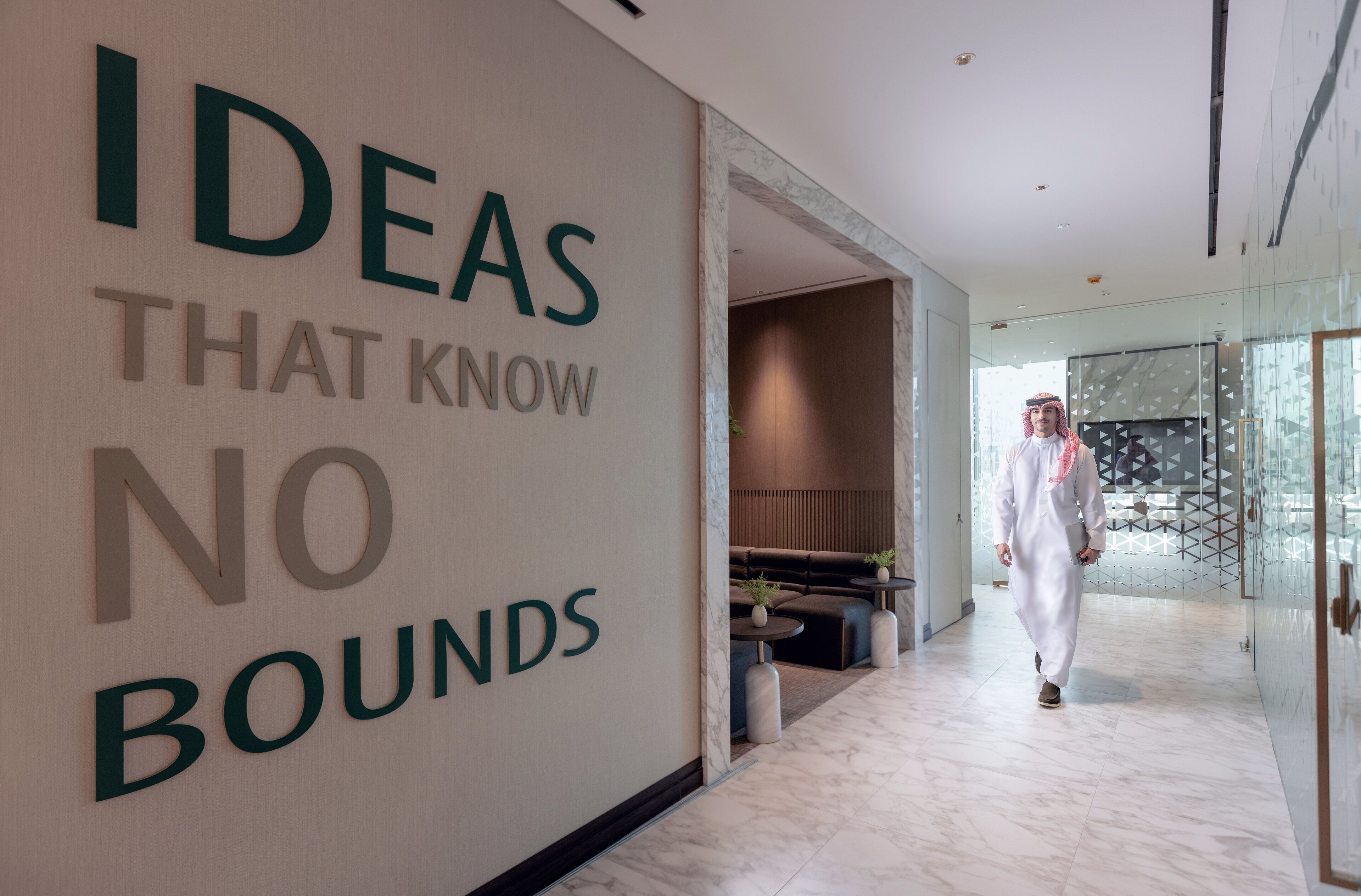 A modern interior with a sign reading "IDEAS THAT KNOW NO BOUNDS".