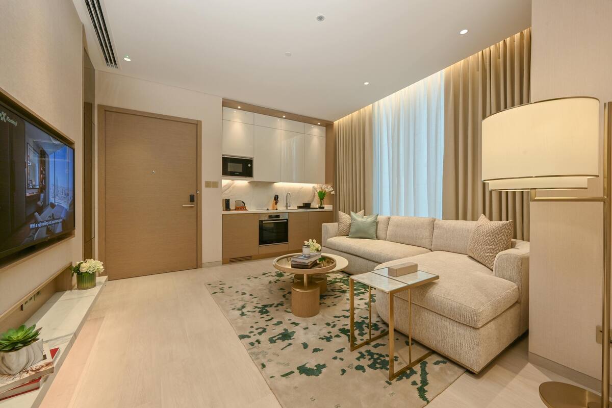 A modern living room with a sofa, coffee table, and TV.
