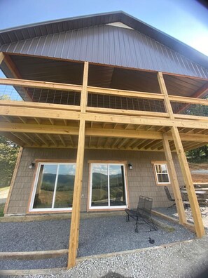 A two-story building with a wooden deck and large windows. - Private Cabin & Views@GraysonHighlands (Grayson County)