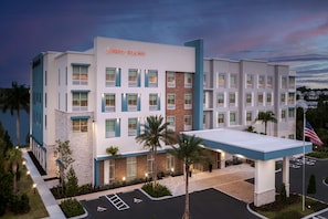 A Hampton Inn & Suites hotel with a modern design, featuring a parking lot and a well-maintained exterior. - Hampton Inn And Suites By Hilton Naples South (Naples)