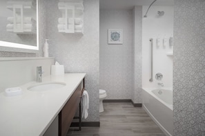 A modern bathroom with a large sink, toilet, and bathtub. - Hampton Inn And Suites By Hilton Naples South (Naples)
