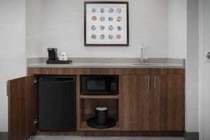 A compact kitchen with a built-in dishwasher, microwave, and coffee maker. - Hampton Inn And Suites By Hilton Naples South (Naples)