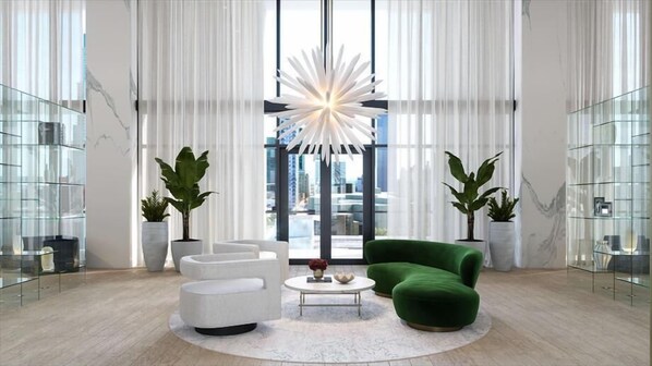 Relax in this serene living space with a large window, starburst-shaped light, and comfortable seating area.
