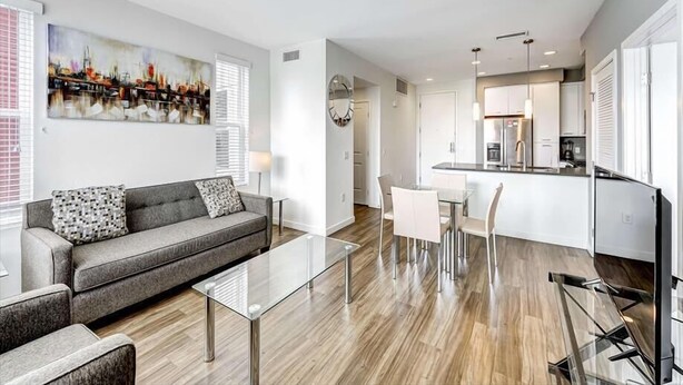 Un appartement moderne comprenant un salon, un coin repas et une cuisine.