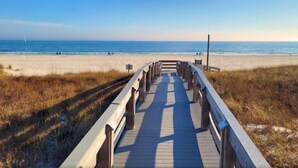 A wooden boardwalk leading to a beach with a clear view of the ocean. - 3 Bedrooms and 3 baths : Beach Facing Condo (Orange Beach)