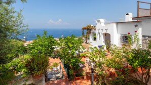 A coastal villa with terracotta roofs, a garden with potted plants, and a view of the sea. - YourHome - Villa Mia (Massa Lubrense)