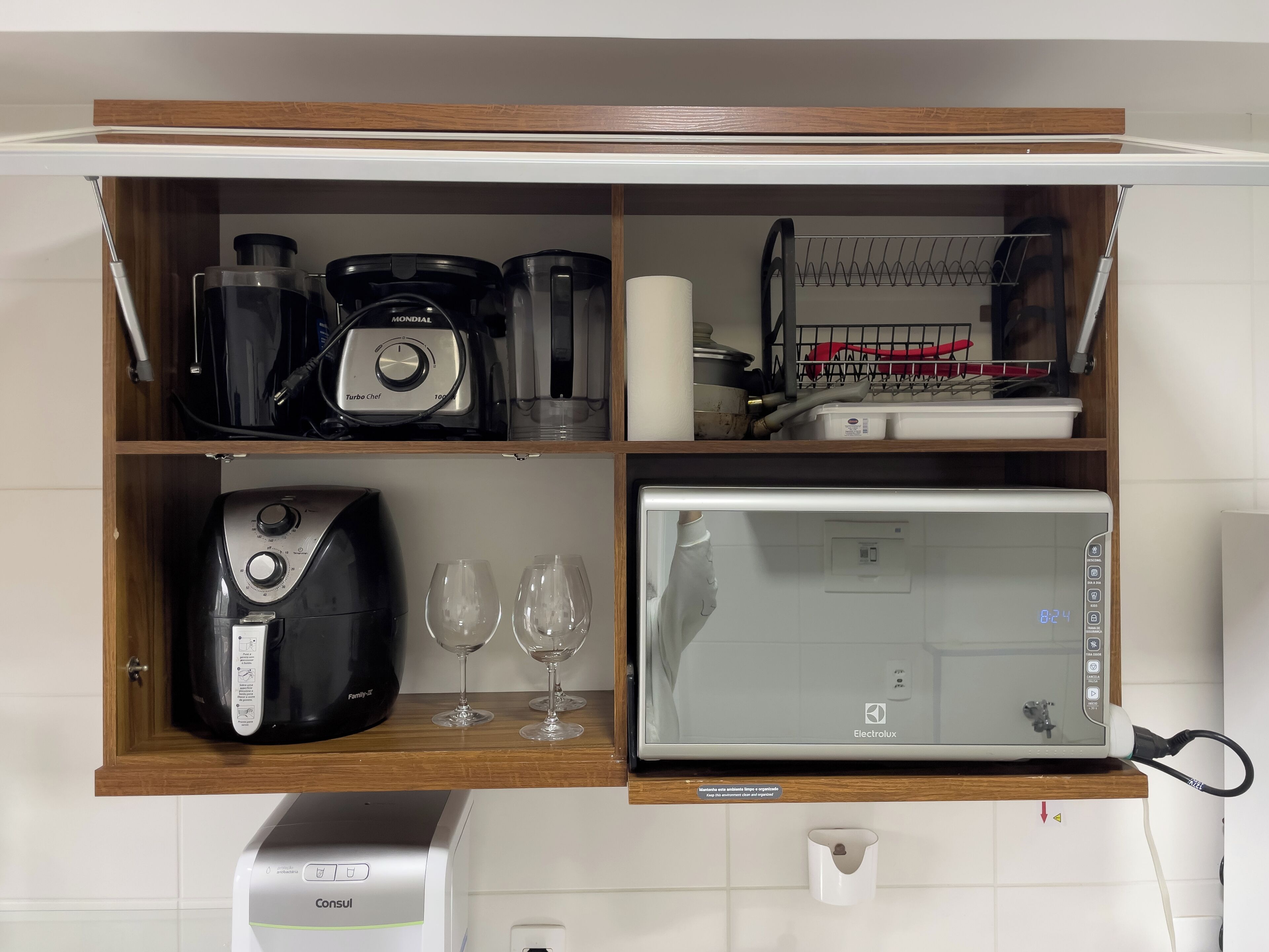 Eine Küche mit integriertem Mikrowellenherd, Kaffeemaschine und Toaster.