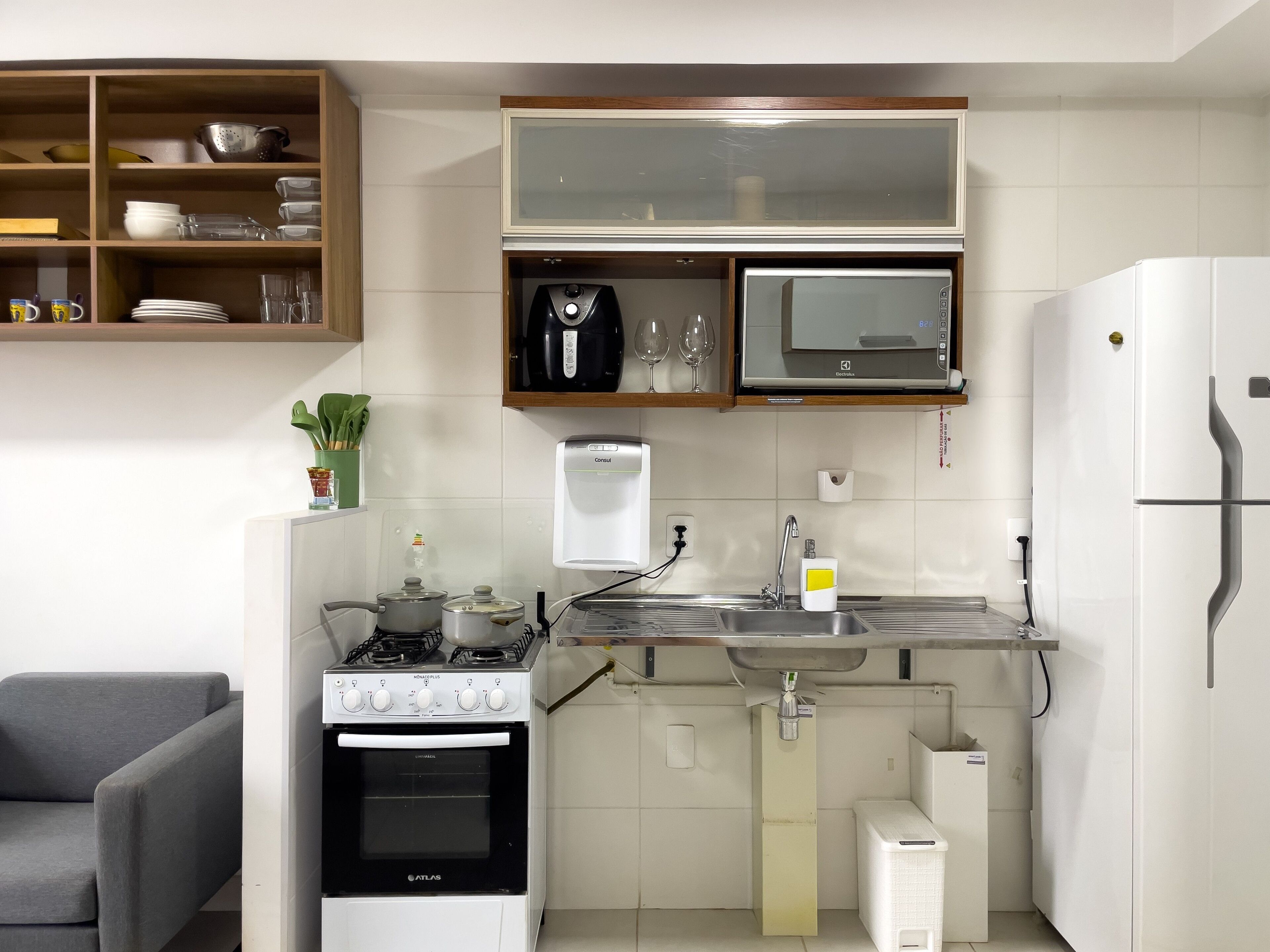 A modern kitchen with a built-in stove, oven, microwave, and refrigerator.