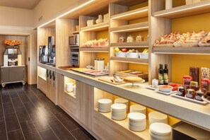 A buffet area with wooden shelves, a coffee station, and various food items. - B&B Hotel Ecija  (Ecija)