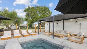 A pool area with lounge chairs and a covered seating area. - The Cypress Bungalows (Sonoma)
