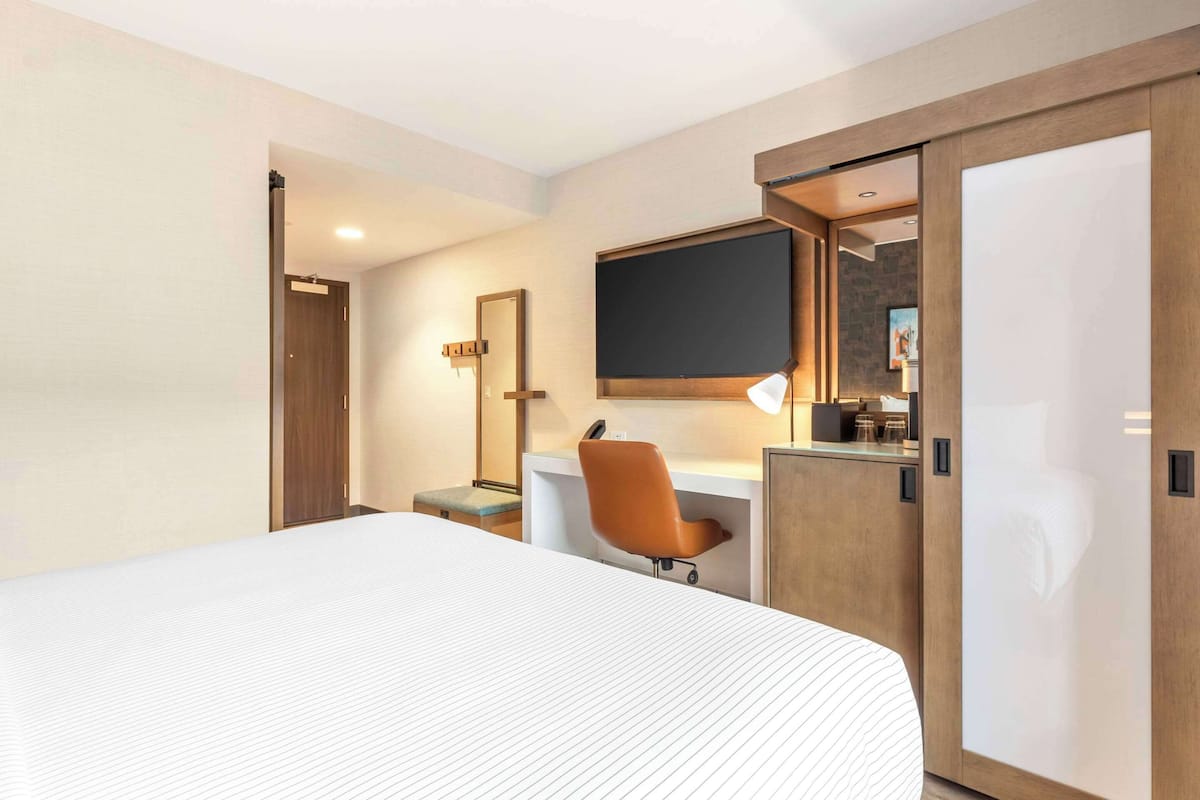 Premium bedding, desk, laptop workspace, blackout curtains