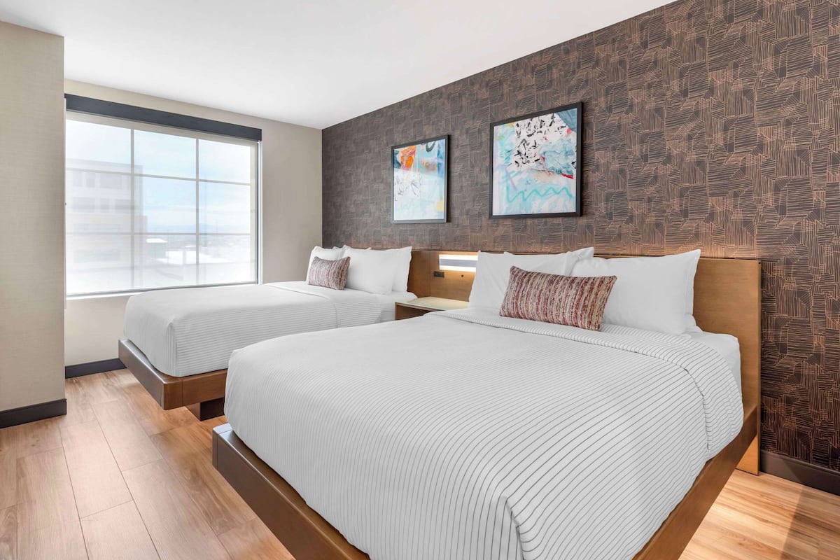 Premium bedding, desk, laptop workspace, blackout drapes