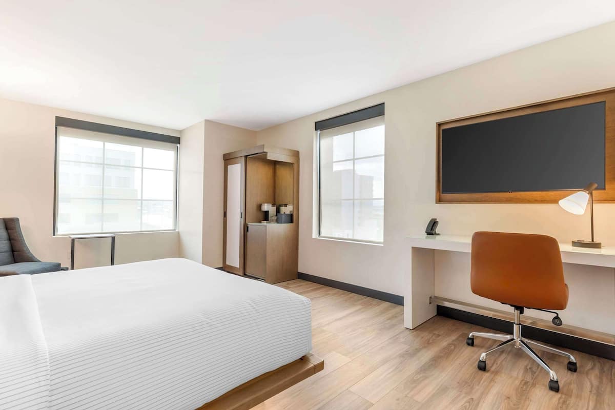 Premium bedding, desk, laptop workspace, blackout drapes
