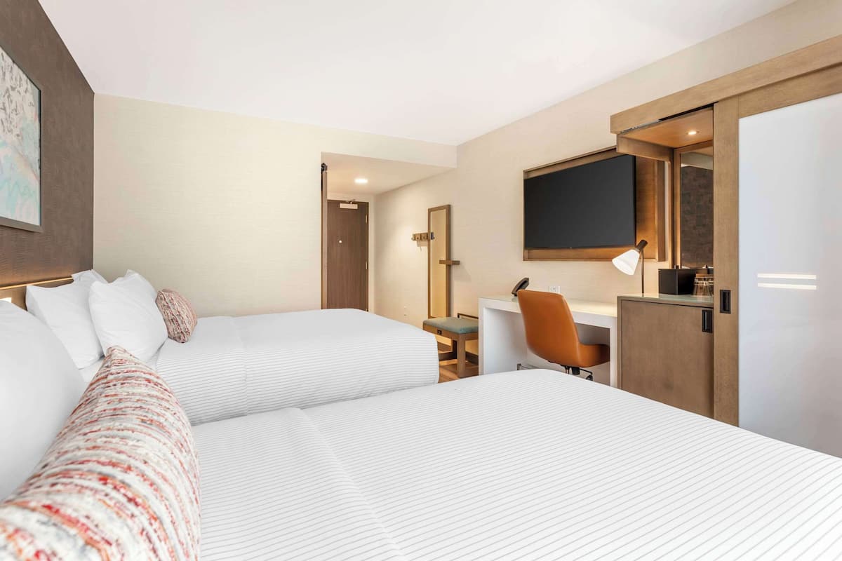 Premium bedding, desk, laptop workspace, blackout drapes