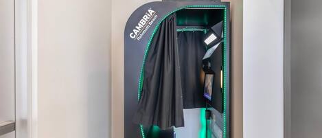 A photo booth with a sign indicating it is located at the 'CAMBRIA Rehoboth Beach' hotel.