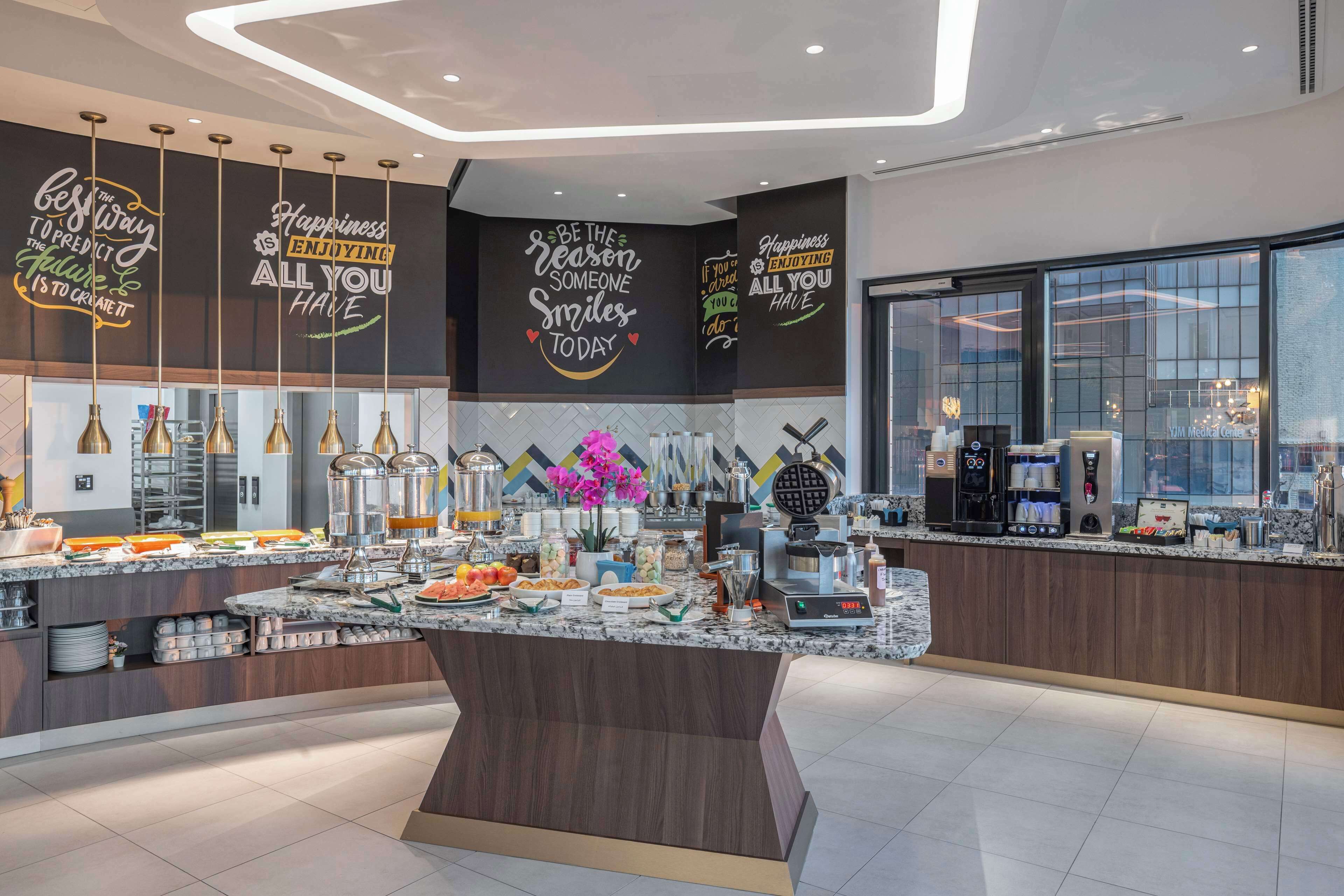 A modern breakfast bar with a variety of food items and a coffee machine.