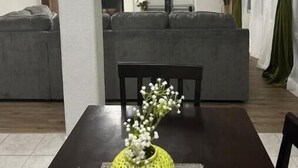 A dining area with a table, chairs, and a decorative vase.