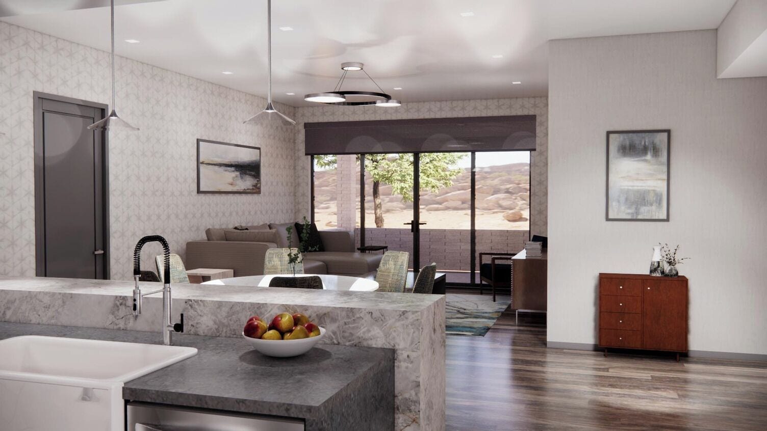 A modern kitchen with a marble countertop, a bowl of fruit, and a sink.