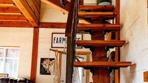 A wooden staircase with a sign reading 'FARM' on the wall.