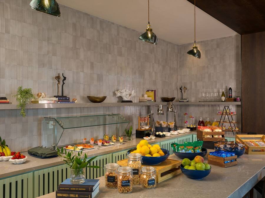 A buffet setup with various food items and condiments.