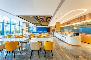 A modern hotel lobby with a breakfast bar, seating area, and large windows. - Holiday Inn Express Beijing Conference Center (Beijing)