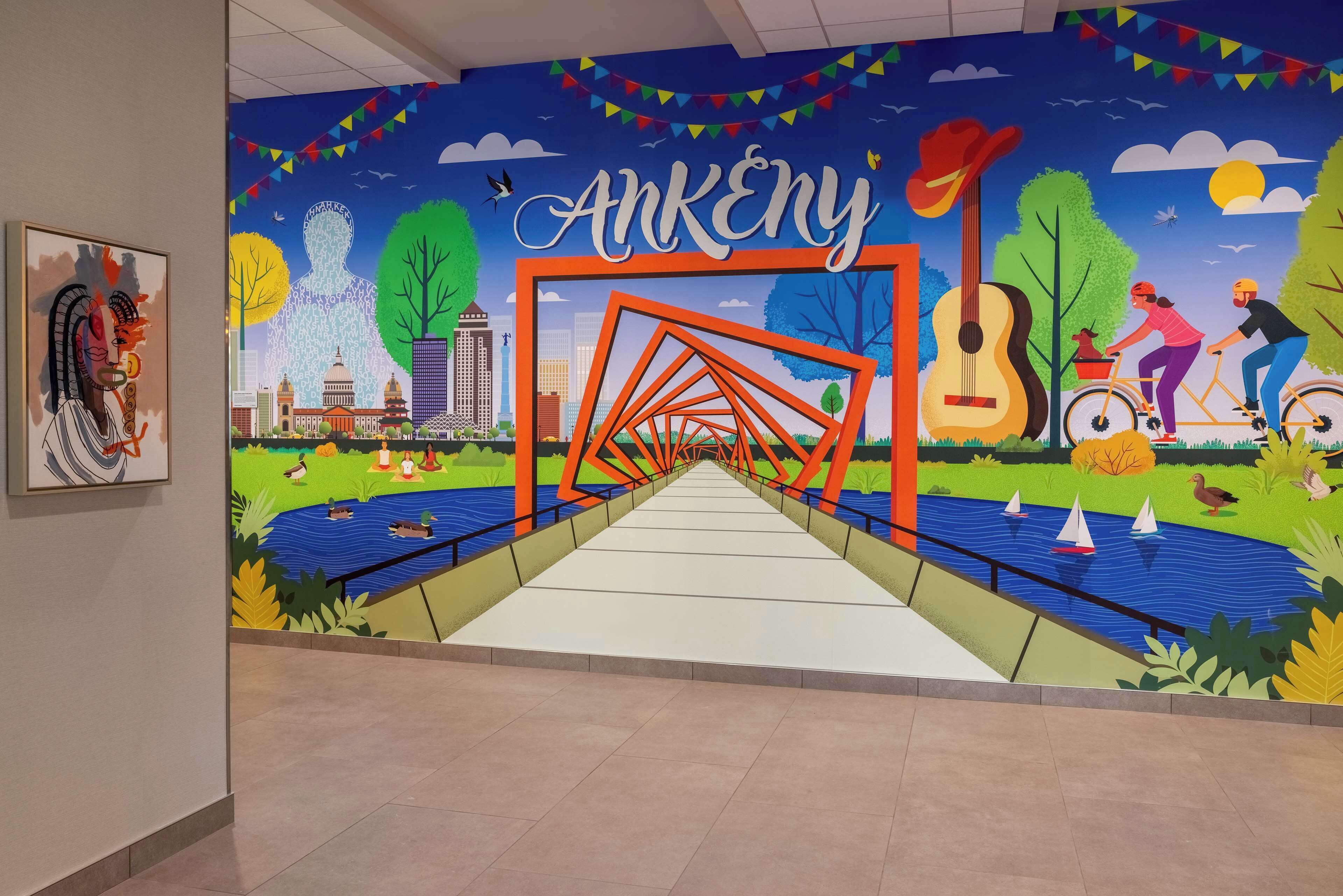 A mural with a bridge, cityscape, and people engaging in activities.