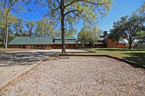 A lodge with a large building, a covered porch, and a gravel area. - Western Lodge - Huge, w/Heated Pool, Hocking Hills (Logan)