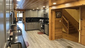 A kitchen with wooden cabinets, a stove, and a microwave.