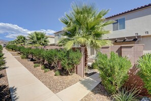 A residential area with a paved walkway, palm trees, and houses with tiled roofs. - Top Tier Townhome in Washington Utah   Private Spa, Pool, Firepit. VS507 (Washington)